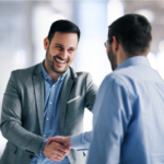 Two businessmen shaking hands in an office