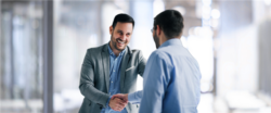 Two businessmen shaking hands in an office